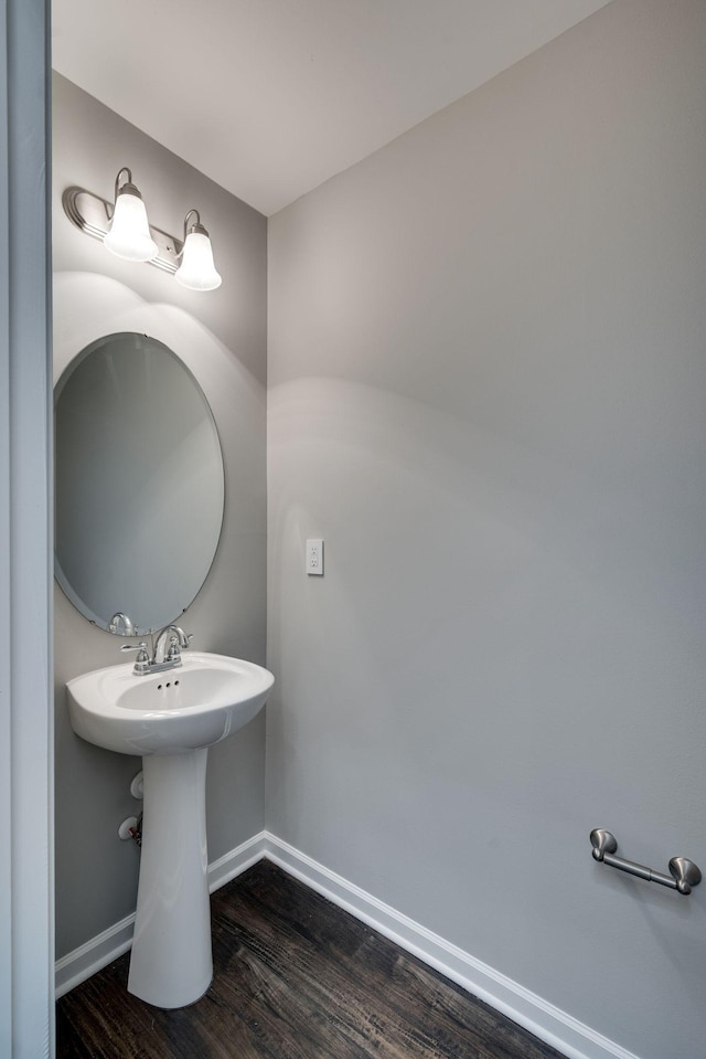 bathroom with wood finished floors and baseboards