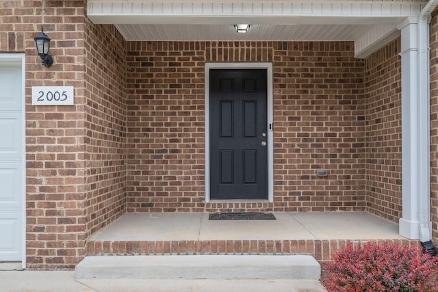 entrance to property with brick siding