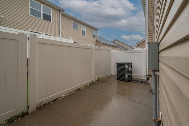 view of patio with central AC unit and fence
