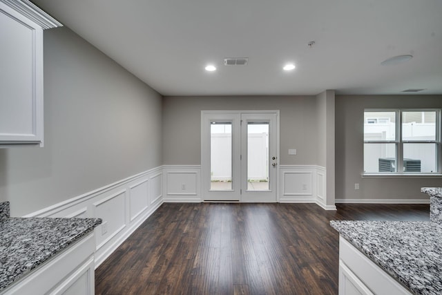 doorway with wainscoting, dark wood finished floors, and recessed lighting