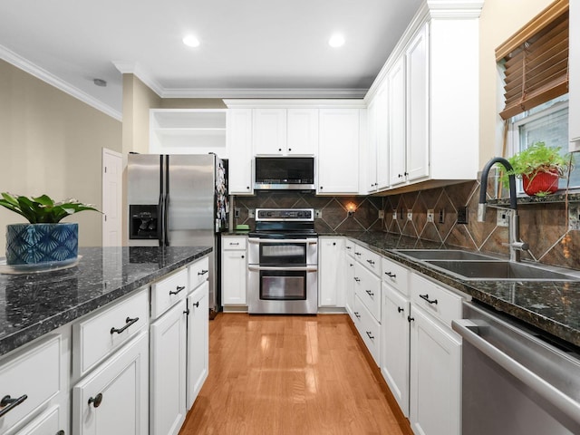 2050 Morrison Ave, Spring Hill, TN 37174 - kitchen with appliances with stainless steel finishes, a sink, ornamental molding, white cabinets, and light wood-style floors