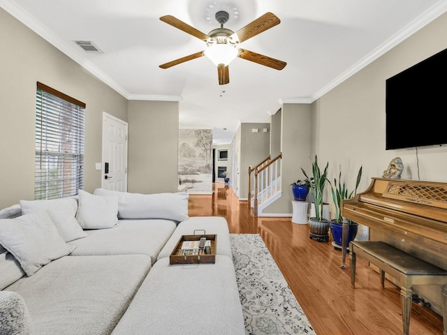 2050 Morrison Ave, Spring Hill, TN 37174 - living area featuring wood finished floors, ornamental molding, a ceiling fan, stairway, and baseboards