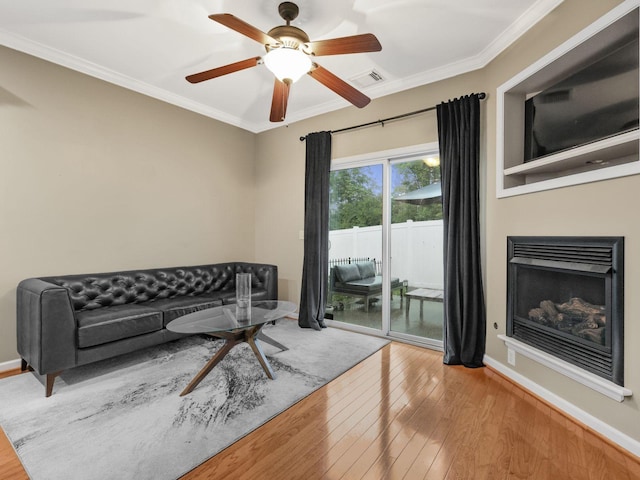 2050 Morrison Ave, Spring Hill, TN 37174 - living area featuring ornamental molding, wood finished floors, a fireplace, a ceiling fan, and baseboards