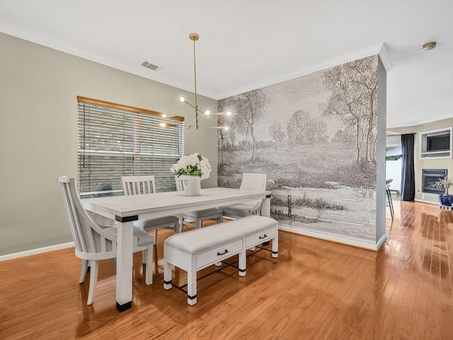 2050 Morrison Ave, Spring Hill, TN 37174 - dining space with hardwood / wood-style flooring, ornamental molding, baseboards, and a glass covered fireplace