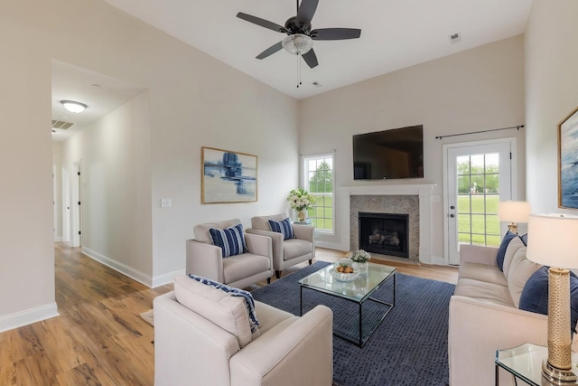 258 Jesse Dr, Pleasant View, TN 37146 - living area with light wood-style flooring, baseboards, a ceiling fan, and a fireplace