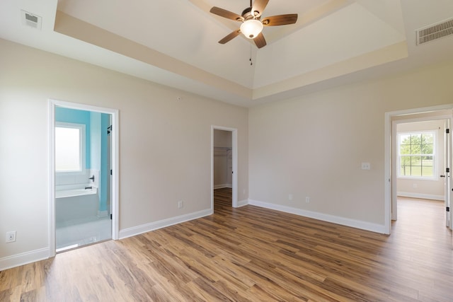 258 Jesse Dr, Pleasant View, TN 37146 - unfurnished bedroom featuring wood finished floors, baseboards, and a walk in closet