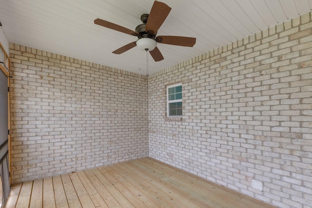 258 Jesse Dr, Pleasant View, TN 37146 - spare room with a ceiling fan, wood-type flooring, and brick wall