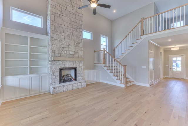 4109 Fargo Ct, Murfreesboro, TN 37127 - unfurnished living room featuring stairway, a ceiling fan, wood finished floors, a stone fireplace, and baseboards