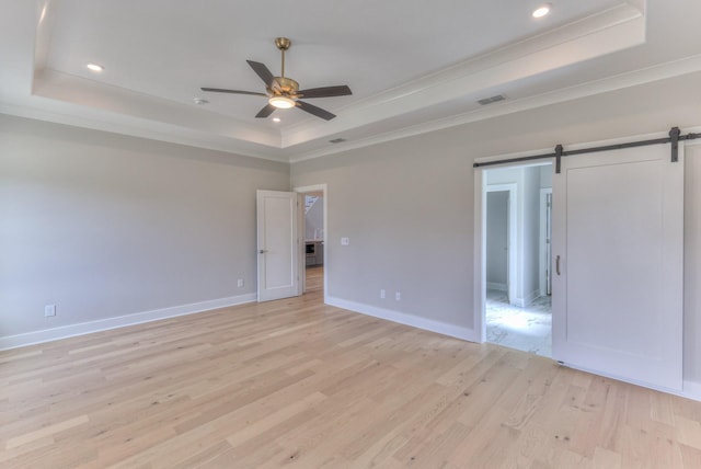 4109 Fargo Ct, Murfreesboro, TN 37127 - spare room with a tray ceiling, ceiling fan, crown molding, light wood-type flooring, and a barn door