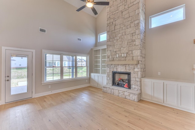 4109 Fargo Ct, Murfreesboro, TN 37127 - unfurnished living room with high vaulted ceiling, light wood-type flooring, plenty of natural light, a stone fireplace, and a ceiling fan