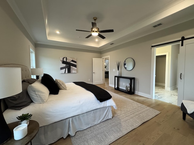 4109 Fargo Ct, Murfreesboro, TN 37127 - bedroom featuring a barn door, a raised ceiling, light wood-type flooring, baseboards, and ceiling fan