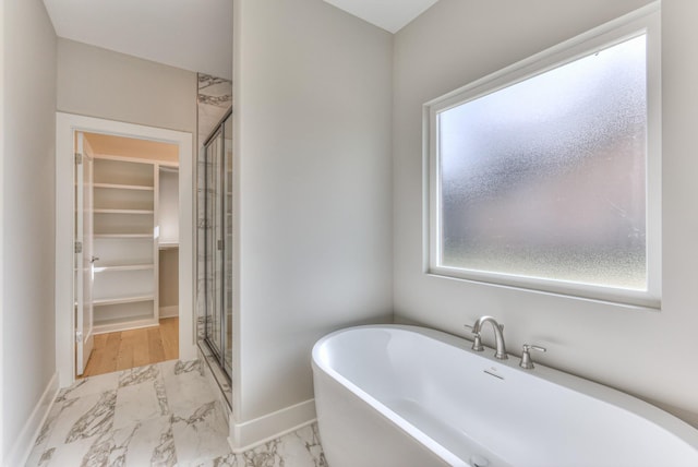 4109 Fargo Ct, Murfreesboro, TN 37127 - bathroom with marble look tile flooring, a spacious closet, a stall shower, and plenty of natural light
