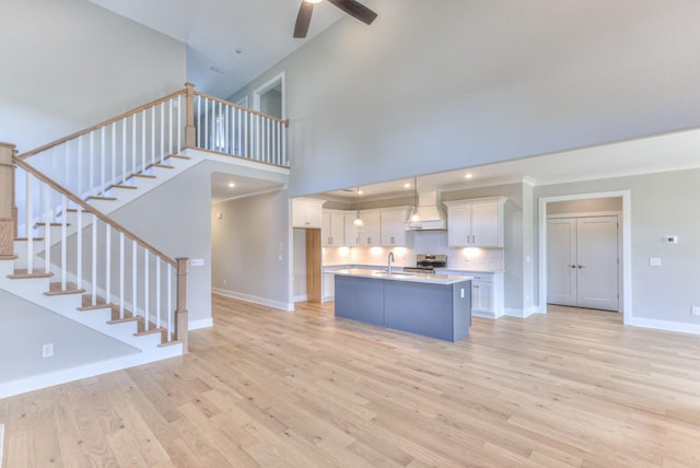4109 Fargo Ct, Murfreesboro, TN 37127 - kitchen featuring a sink, white cabinets, stainless steel range with electric stovetop, ceiling fan, and light wood-style flooring