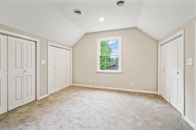 2506 Morgan Rd, Murfreesboro, TN 37129 - unfurnished bedroom with carpet, multiple closets, vaulted ceiling, and baseboards