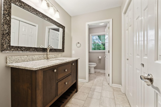 2506 Morgan Rd, Murfreesboro, TN 37129 - bathroom with toilet, vanity, baseboards, and a closet