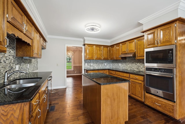2506 Morgan Rd, Murfreesboro, TN 37129 - kitchen featuring stainless steel appliances, a sink, brown cabinets, a kitchen island, and ornamental molding