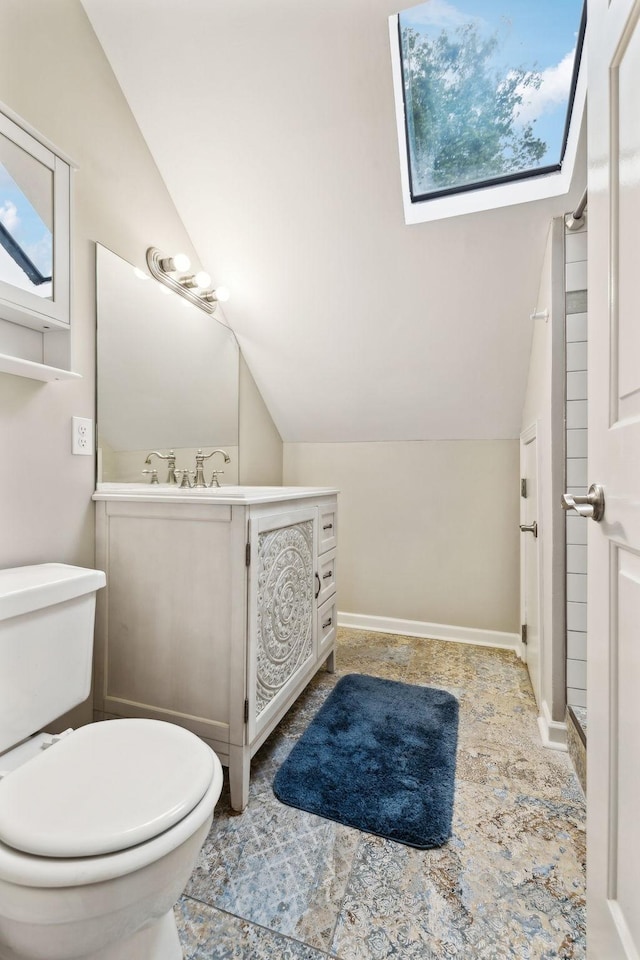 2506 Morgan Rd, Murfreesboro, TN 37129 - bathroom with lofted ceiling, toilet, vanity, a skylight, and baseboards
