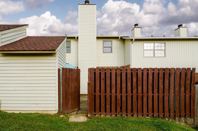 163 Heritage Trace Dr, Madison, TN 37115 - rear view of house featuring a chimney, fence, and a shingled roof