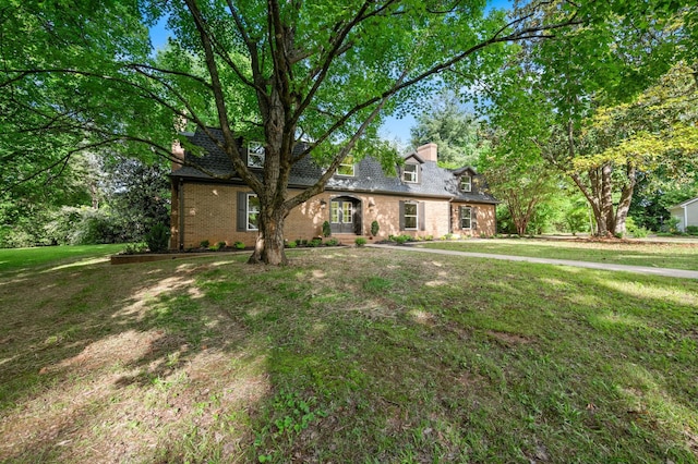 1311 Halifax Ct, Murfreesboro, TN 37130 - cape cod home with brick siding, a front lawn, and a chimney