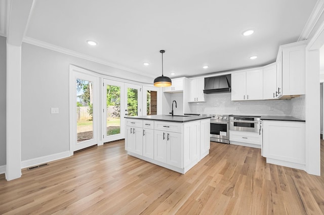 1311 Halifax Ct, Murfreesboro, TN 37130 - kitchen with dark countertops, wall chimney range hood, appliances with stainless steel finishes, ornamental molding, and light wood-style floors