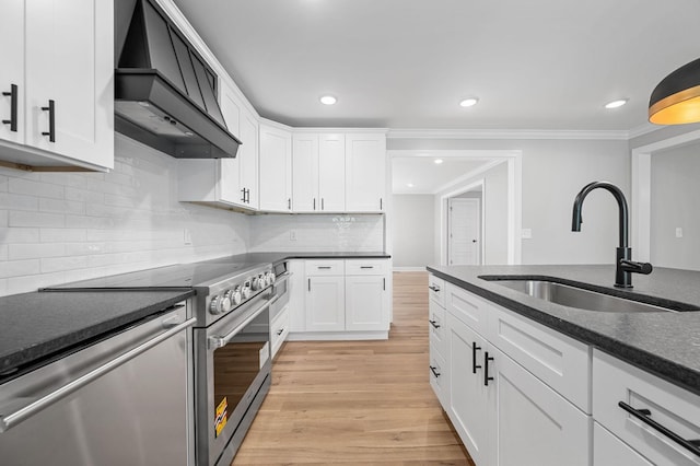 1311 Halifax Ct, Murfreesboro, TN 37130 - kitchen with appliances with stainless steel finishes, premium range hood, a sink, light wood-style floors, and white cabinetry