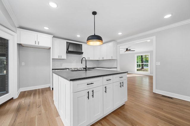 1311 Halifax Ct, Murfreesboro, TN 37130 - kitchen with dark countertops, a sink, premium range hood, crown molding, and baseboards
