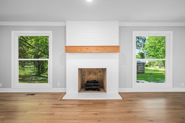 1311 Halifax Ct, Murfreesboro, TN 37130 - unfurnished living room featuring baseboards, wood finished floors, healthy amount of natural light, and ornamental molding