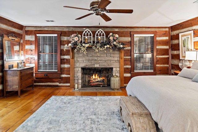 2133 Allisona Rd, Eagleville, TN 37060 - bedroom with wooden walls, wood-type flooring, and a fireplace