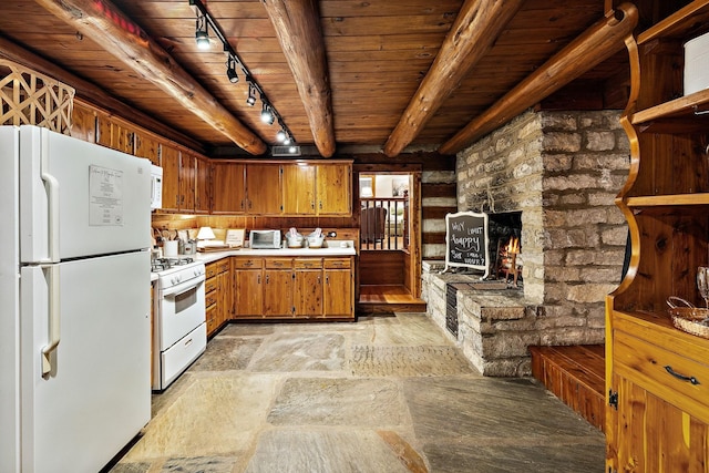 2133 Allisona Rd, Eagleville, TN 37060 - kitchen with white appliances, track lighting, wood ceiling, light countertops, and brown cabinetry