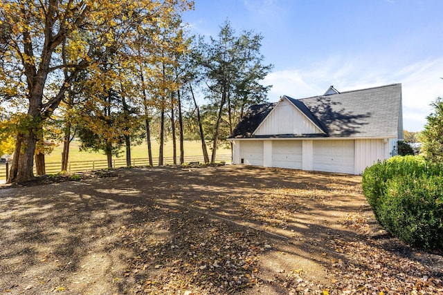 2133 Allisona Rd, Eagleville, TN 37060 - view of home's exterior with an outdoor structure, dirt driveway, a garage, and a shingled roof