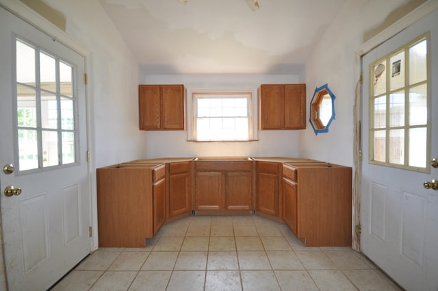 5620 Sango Rd, Clarksville, TN 37043 - kitchen with healthy amount of natural light, brown cabinets, and light tile patterned floors