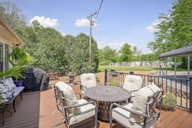 deck with outdoor dining area and area for grilling