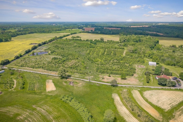 aerial view of property and surrounding area featuring rural landscape and a large body of water