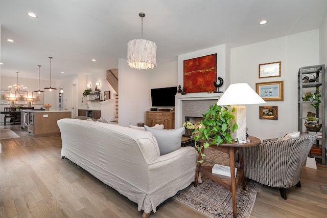 1411B Boscobel St, Nashville, TN 37206 - living room featuring a chandelier, light wood-style flooring, recessed lighting, a fireplace, and stairs