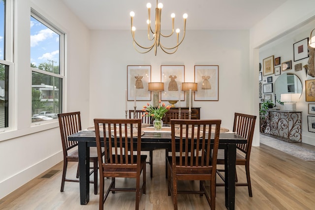 1411B Boscobel St, Nashville, TN 37206 - dining space featuring a chandelier, light wood-style floors, and baseboards