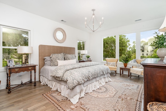 1411B Boscobel St, Nashville, TN 37206 - bedroom with light wood-style flooring and a chandelier