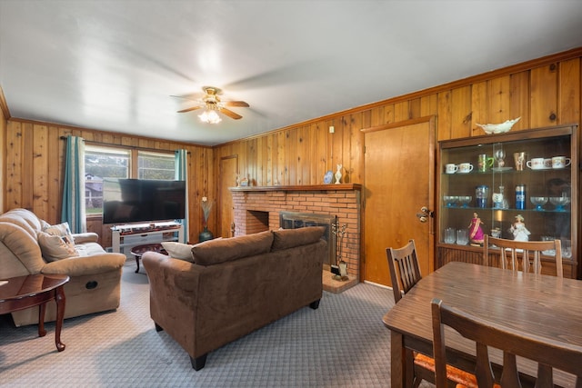 511 Catalina Dr, Nashville, TN 37217 - carpeted living area featuring wood walls, ceiling fan, crown molding, and a brick fireplace