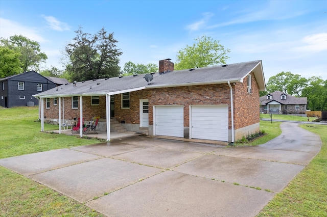 511 Catalina Dr, Nashville, TN 37217 - back of property with brick siding, concrete driveway, a chimney, a lawn, and a garage