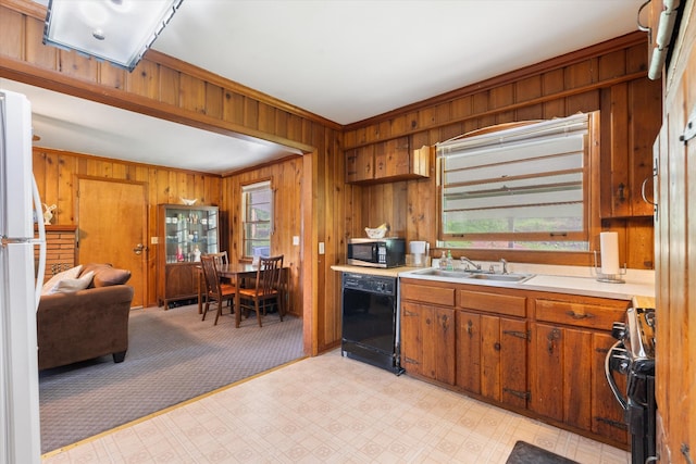 511 Catalina Dr, Nashville, TN 37217 - kitchen with dishwasher, range, ornamental molding, wooden walls, and light countertops