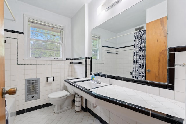 511 Catalina Dr, Nashville, TN 37217 - full bathroom featuring heating unit, a shower with curtain, tile walls, toilet, and tile patterned flooring