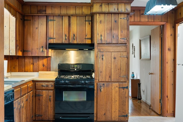 511 Catalina Dr, Nashville, TN 37217 - kitchen featuring black appliances, under cabinet range hood, brown cabinets, light countertops, and light wood finished floors