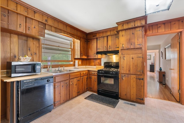 511 Catalina Dr, Nashville, TN 37217 - kitchen featuring black appliances, a sink, under cabinet range hood, light countertops, and brown cabinets
