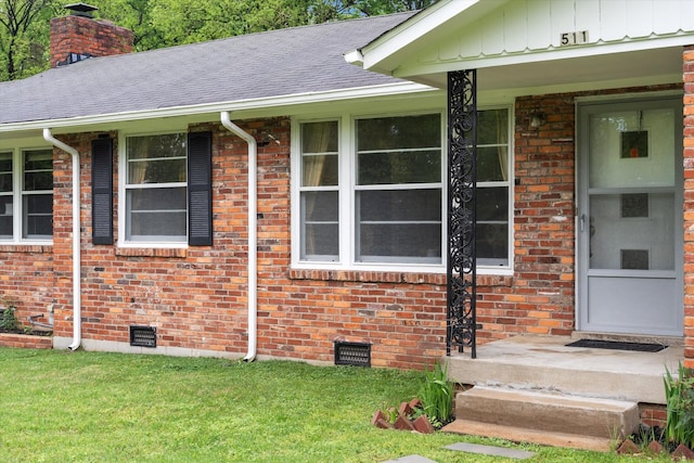 511 Catalina Dr, Nashville, TN 37217 - property entrance featuring a chimney, brick siding, crawl space, and a yard