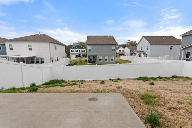fenced backyard featuring a residential view and a patio area