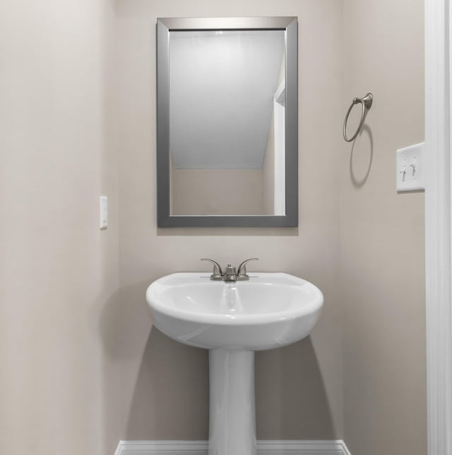 bathroom with baseboards and a sink