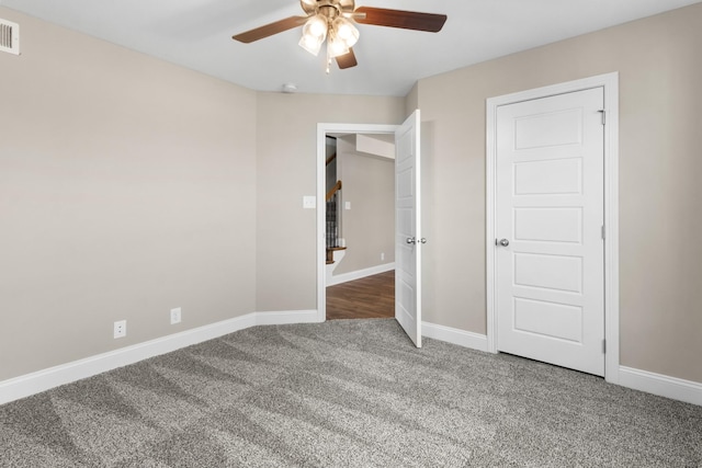 unfurnished bedroom with carpet floors, baseboards, and a ceiling fan