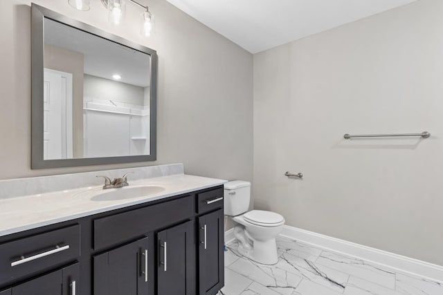 full bathroom featuring marble look tile flooring, baseboards, vanity, and toilet
