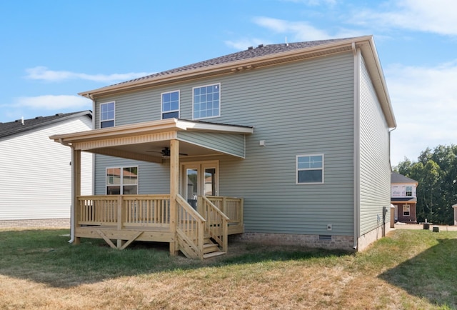 back of property with a ceiling fan, a yard, and crawl space