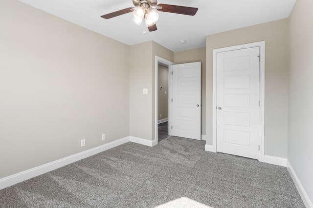 unfurnished bedroom with carpet, baseboards, and ceiling fan