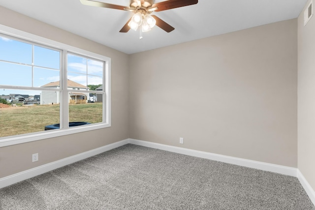 spare room featuring baseboards, carpet floors, and ceiling fan